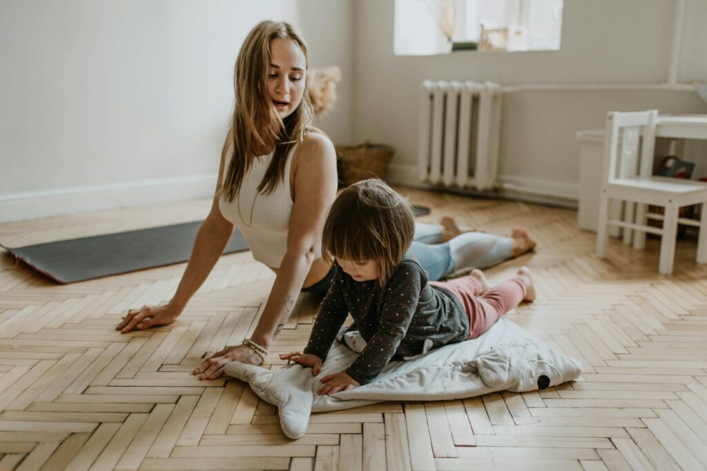Mother teaching daughter yoga