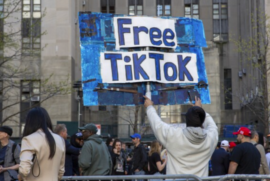 Protesters holding "Free TikTok" banners - EasyComment